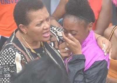 Dr. Cheryl Dozier, president of Savannah State University, comforts a grieving student.