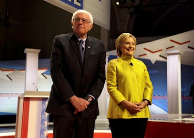 Democratic presidential candidates Sen. Bernie Sanders, left, and Hillary Clinton take the stage before a Democratic presidential primary debate at the University of Wisconsin-Milwaukee, Thursday, Feb. 11, 2016, in Milwaukee. (AP Photo/Tom Lynn)
