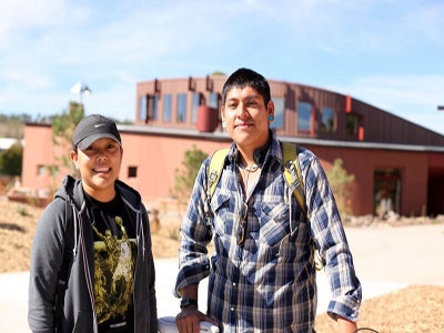 Students stand in front of NAU’s Native American Cultural Center, home to more than 1,500 students from 127 tribes. (Photo courtesy of Northern Arizona University)