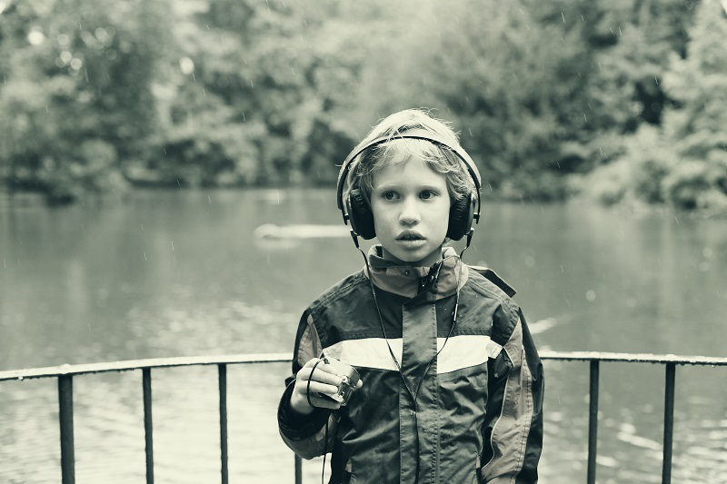Portrait of cute autistic boy with headphones
