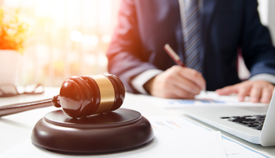 Wooden gavel on table. Attorney working in courtroom.