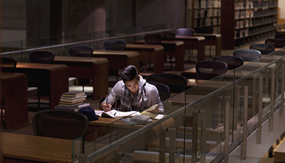Student working in library at night