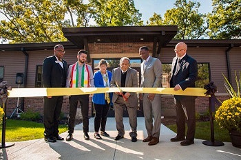 Andrew Young, center, cuts the ribbon at the center.