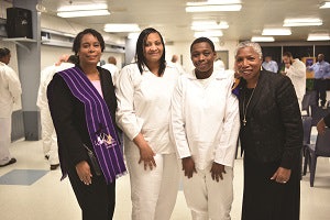 Graduates LaShaun Chidester (center left) and Lestine Robinson (center right) are congratulated by members of Women in Ministry.