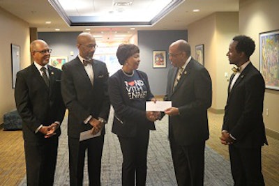 Dr. Everett B. Ward hands Dr. Phyllis Worthy Dawkins a check in support of Bennett College.