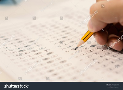 stock-photo-optical-form-of-standardized-test-with-answers-bubbled-and-a-black-pencil-examination-answer-sheet-727523344