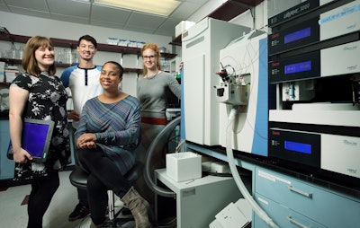 Dr. Namandjé Bumpus, center, in her Hopkins lab.