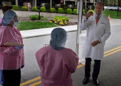 Dr. James E.K. Hildreth with testing workers.