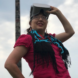 Dr. Caroline Running Wolf with a virtual reality headset.