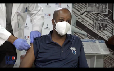 Dr. Wayne A. I. Frederick, president of Howard University, receives a COVID-19 vaccine
