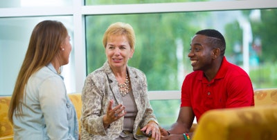 Dr. Susan West Engelkemeyer converses with students. Hearing their stories, she says, has been among the most rewarding parts of her job.