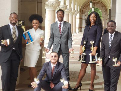 Members of the Wiley debate team pose with their awards.