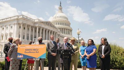 Sen. Chris Coons speaks at the IGNITE announcement in Washington, D.C., with Rep. Alma Adams standing behind him.