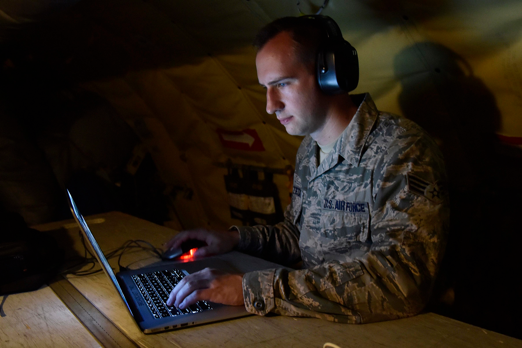 Senior Airman Ryan Zeski uses time during a long flight to work on some homework for a course he is taking at Oakland University.