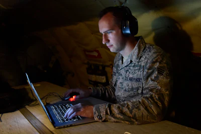 Senior Airman Ryan Zeski uses time during a long flight to work on some homework for a course he is taking at Oakland University.