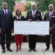 Alabama A&M leadership pose with a donation check totaling $2,187,518.75.