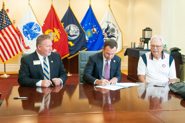 Georgia Southern Vice President for Enrollment Management Scot Lingrell and Vice President for University Advancement Trip Addison and The Landings Military Family Relief Fund Inc. Board of Directors Chairman Bob Longueira sign an agreement for a new scholarship fund designed for spouses of military service members.