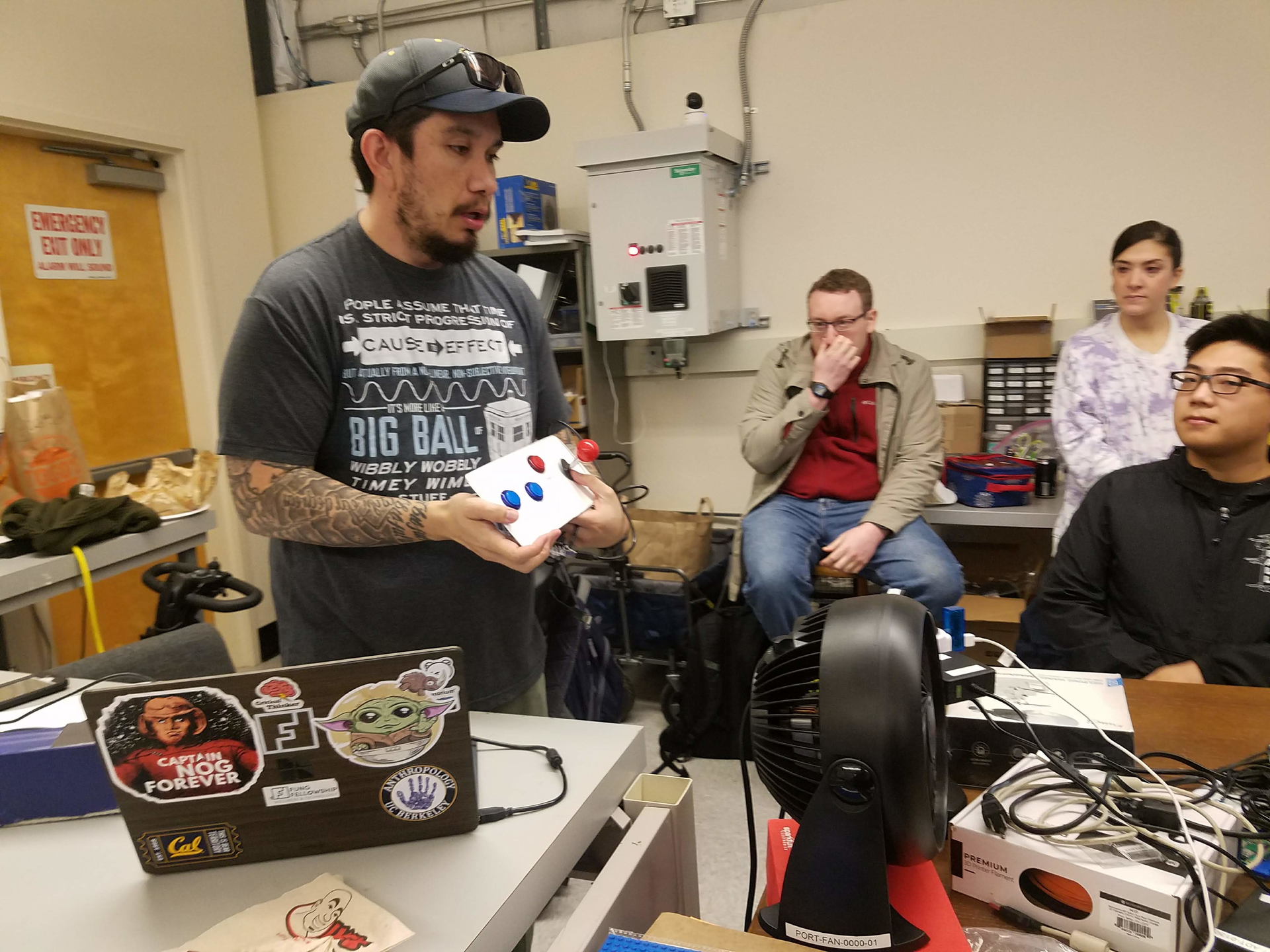 Nate Tilton, far left, holds up a low-cost accessible gaming controller made at the lab.