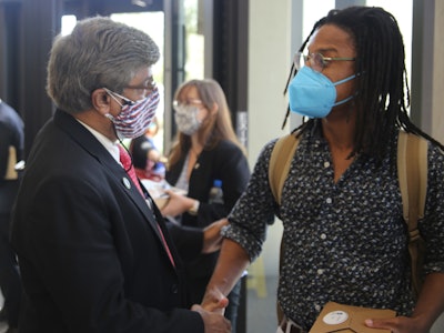 NSF Director Sethuraman Panchanathan greets University of Kansas Ecology and Evolutionary Biology Assistant Professor Brian Atkinson