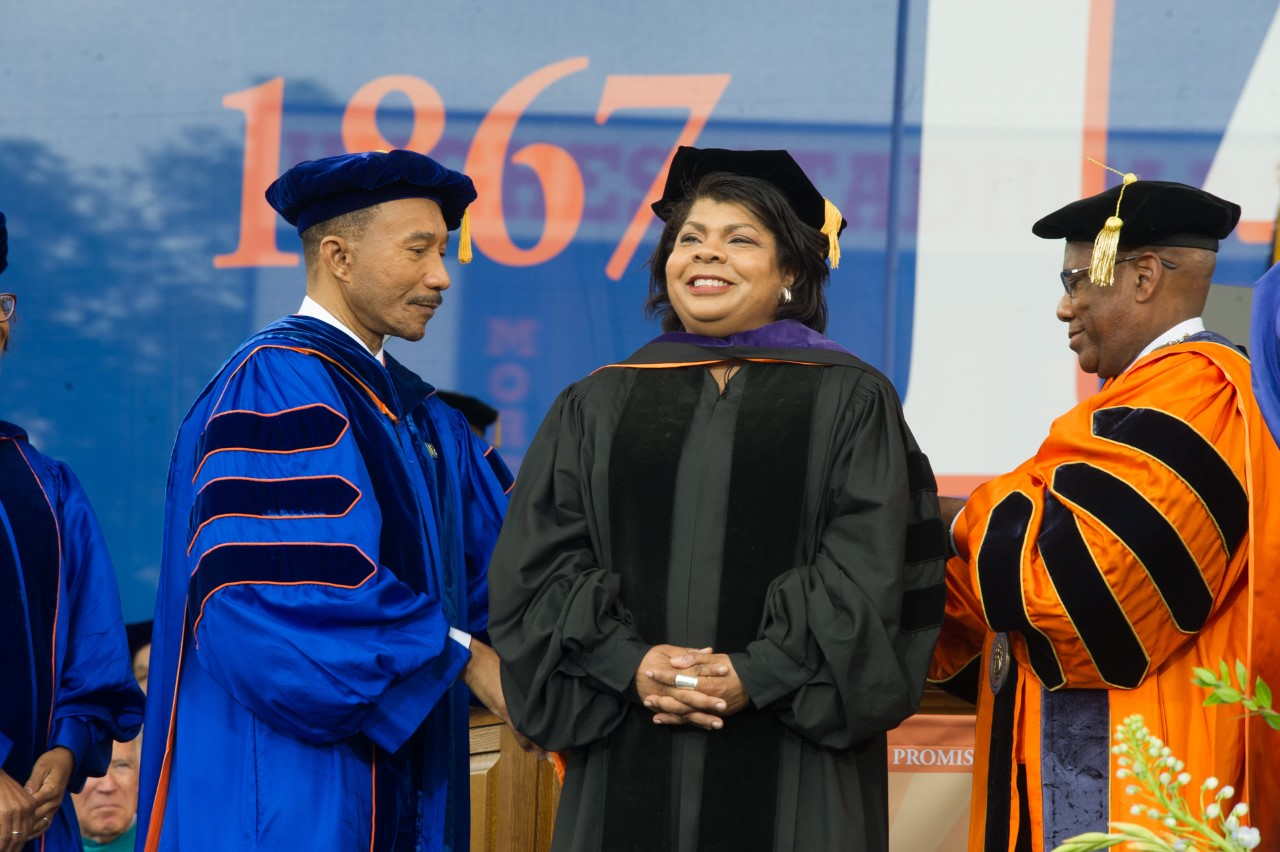 April Ryan with MSU Board of Regent Chair Congressman Kweisi Mfume (left) and MSU President David K. Wilson as she receives an honorary Doctor of Laws degree at Morgan Commencement Ceremony in 2017.