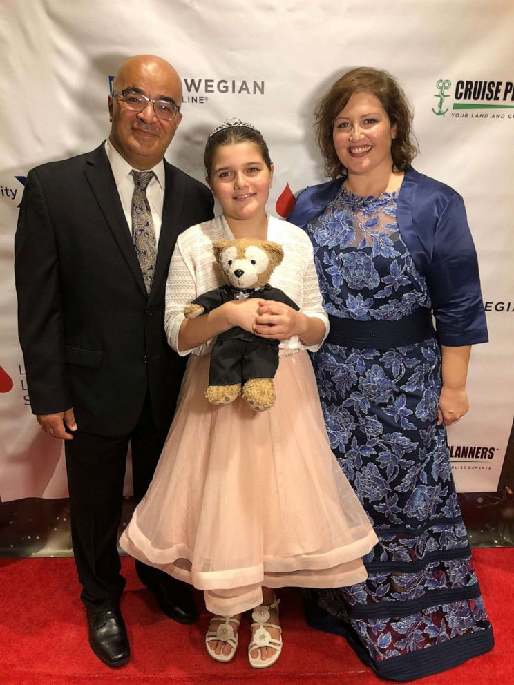 12-year-old Sawsan Ahmed with her father and mother.