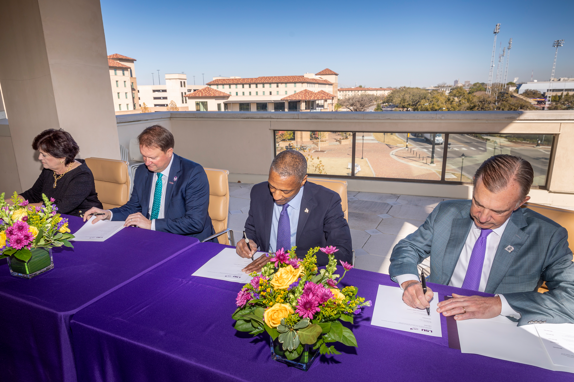 LSU officials and representatives from Our Lady of the Lake and LCMC Health sign the $245 million agreement.