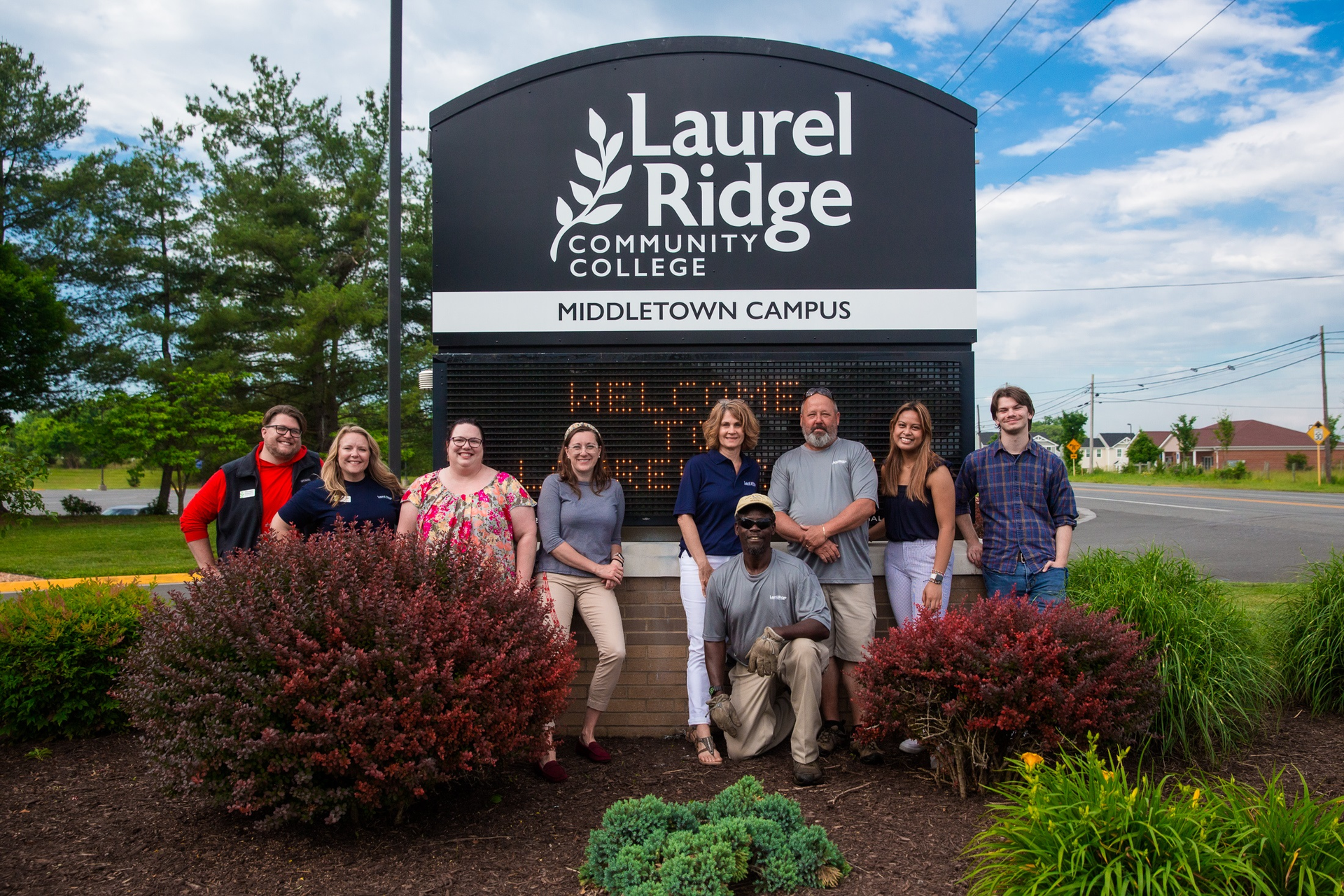 Staff at Laurel Ridge Community College's Middletown Campus stand next to their new sign. The college changed its name on June 3, from Lord Fairfax Community College.