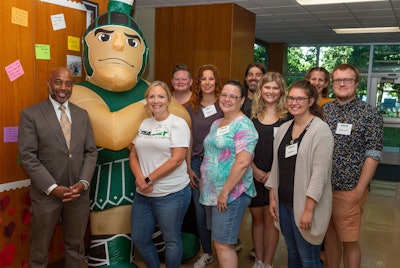 Dr. Jerlando F. L. Jackson (left) meets with scholars and students in the Michigan State University Master of Arts in Educational Technology program at Erickson Hall.