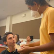 Law student Josh Bertalotto of the Tunica Biloxi Tribe talks with an audience member at an Indigenous youth event.
