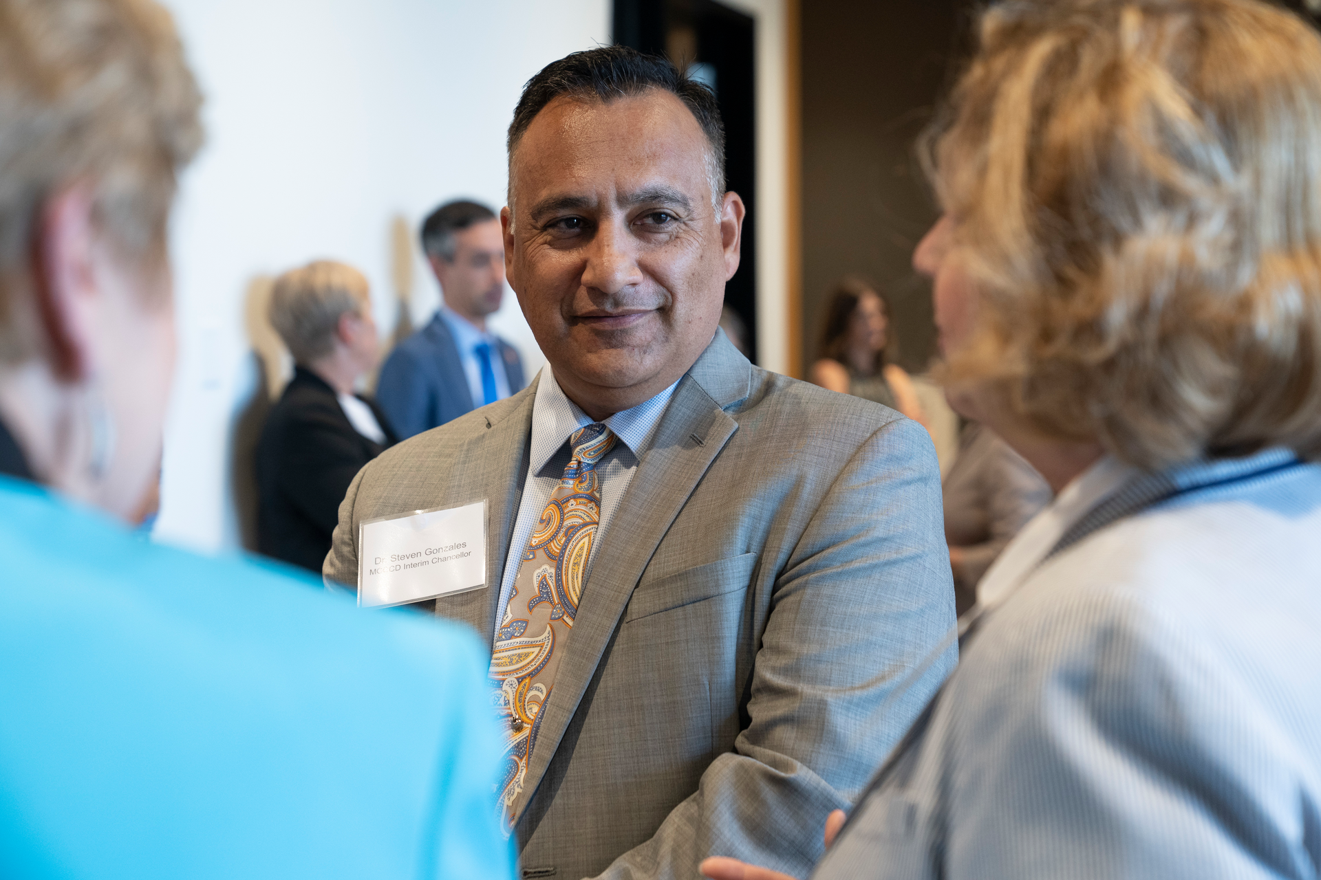 Higher education leaders say Dr. Steven R. Gonzales (center) brings a unique-but-relatable perspective to serving first-generation and underprivileged students as chancellor of the Maricopa County Community College District.