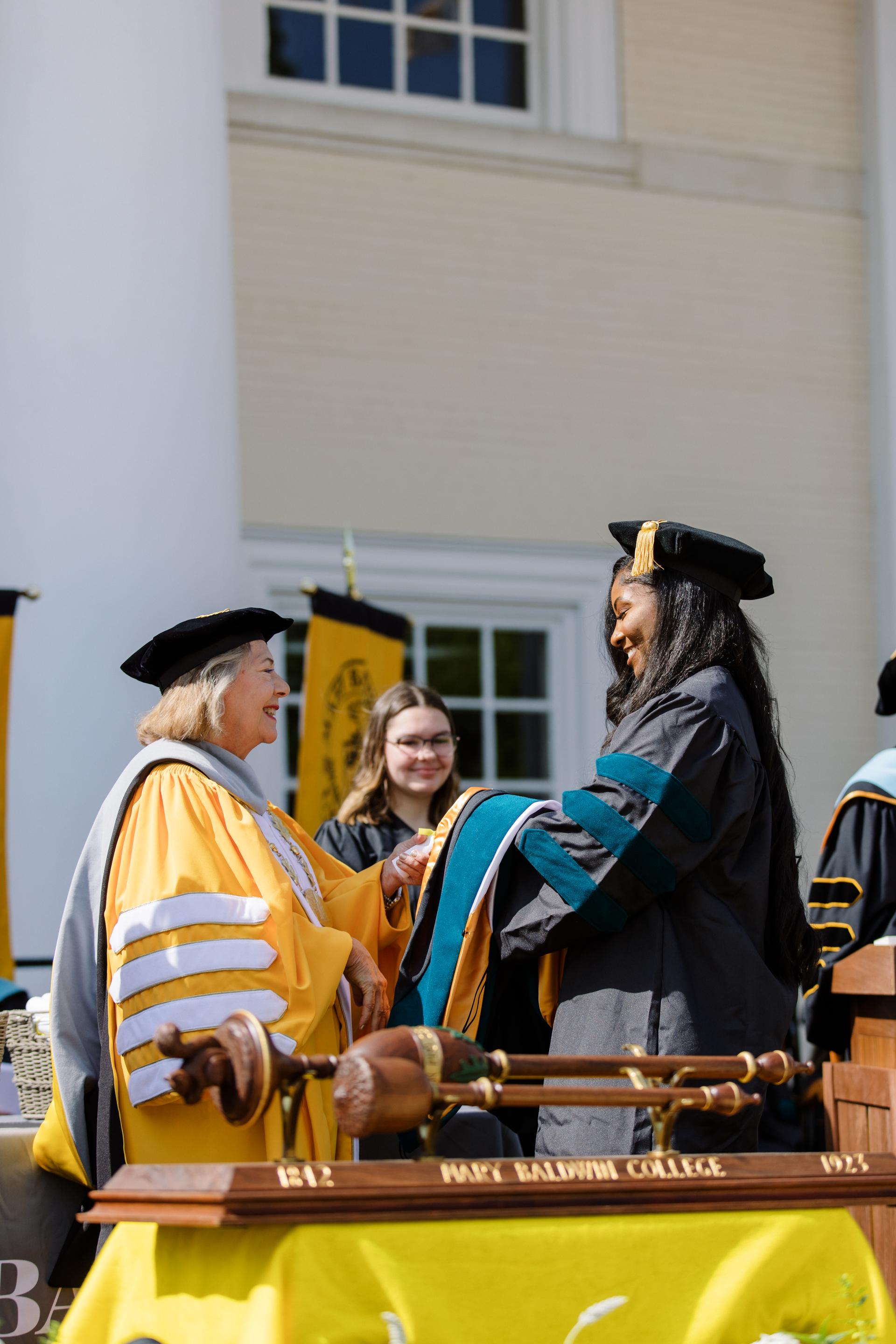Dr. Pamela R. Fox congratulates a doctor of occupational therapy graduate during a 2023 commencement ceremony.