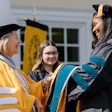 Dr. Pamela R. Fox congratulates a doctor of occupational therapy graduate during a 2023 commencement ceremony.