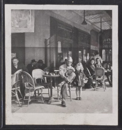 WW II Veteran at sidewalk café with five year old Yvette Doray, Paris, France.