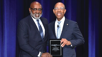 Dr. Charles Alexander is shown with Dr. Michael Drake, president of the University of California.