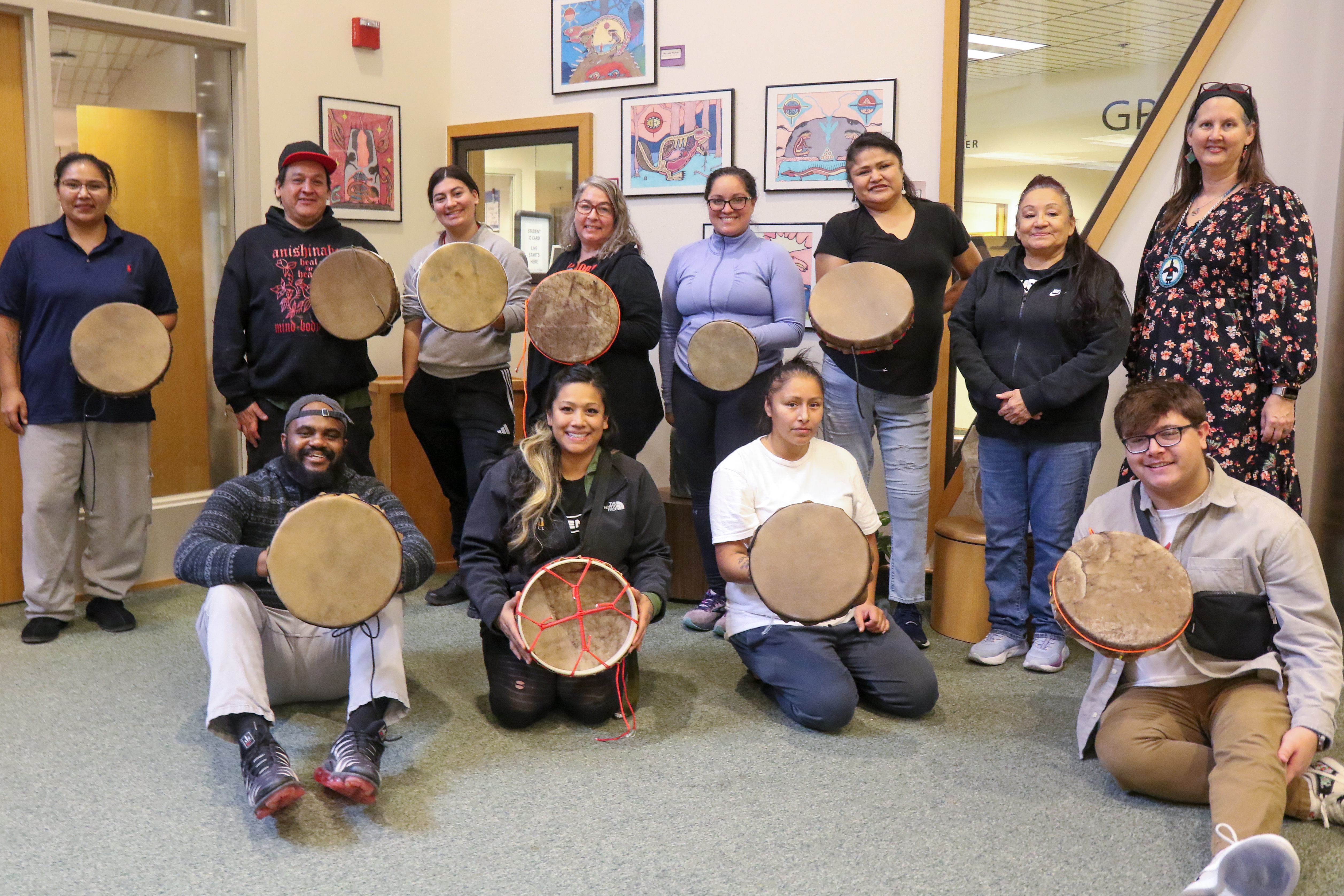 Group photo with completed projects at Drum Making Workshop hosted by Ojibwemowining Digital Arts Studio at FDLTCC