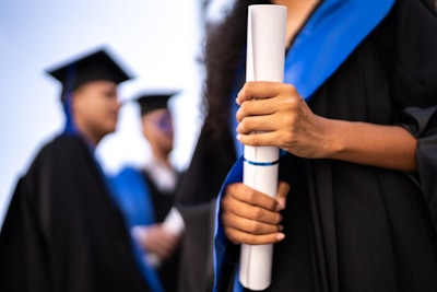 Young Woman Holding A Diploma On Graduation 768x512