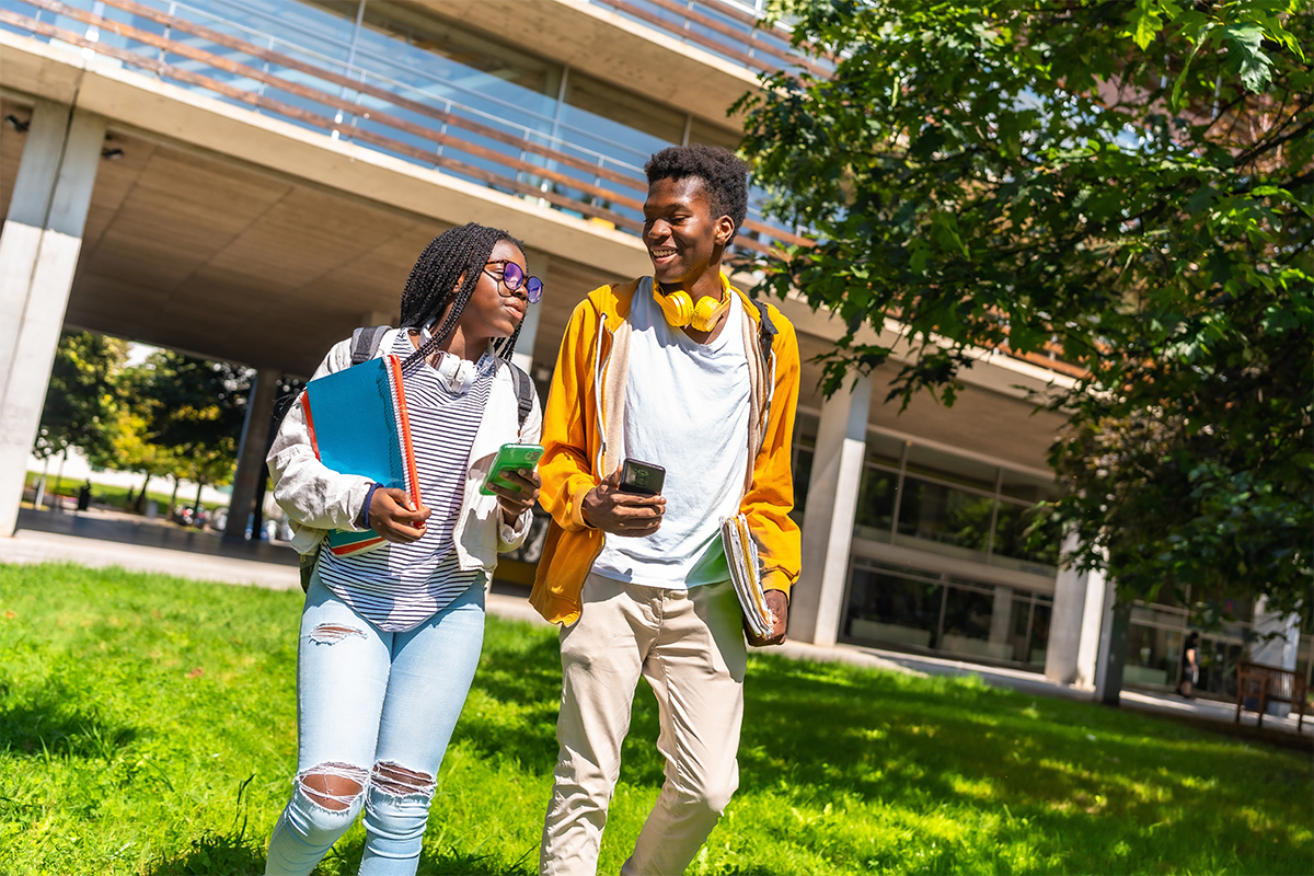 Two Students Walking Outside Campus 1200x800 1
