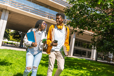 Two Students Walking Outside Campus 1200x800 1