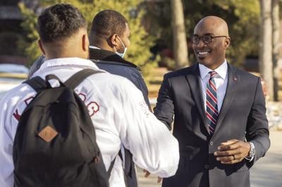 Dr. James Minor meeting students on campus.
