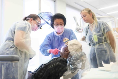 Dental faculty and students perform procedure on a veteran.