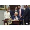 President Donald Trump signs an executive order restarting the Presidential Fitness Test in public schools as Secretary of Education Linda McMahon, from left, Treasury Secretary Scott Bessent, Commerce Secretary Howard Lutnick, Vice President JD Vance and professional golfer Bryson DeChambeau watch, Thursday, July 31, 2025, in the Roosevelt Room of the White House in Washington. (AP Photo/Jacquelyn Martin)