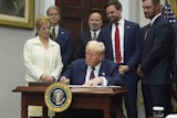 President Donald Trump signs an executive order restarting the Presidential Fitness Test in public schools as Secretary of Education Linda McMahon, from left, Treasury Secretary Scott Bessent, Commerce Secretary Howard Lutnick, Vice President JD Vance and professional golfer Bryson DeChambeau watch, Thursday, July 31, 2025, in the Roosevelt Room of the White House in Washington. (AP Photo/Jacquelyn Martin)