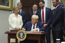 President Donald Trump signs an executive order restarting the Presidential Fitness Test in public schools as Secretary of Education Linda McMahon, from left, Treasury Secretary Scott Bessent, Commerce Secretary Howard Lutnick, Vice President JD Vance and professional golfer Bryson DeChambeau watch, Thursday, July 31, 2025, in the Roosevelt Room of the White House in Washington. (AP Photo/Jacquelyn Martin)