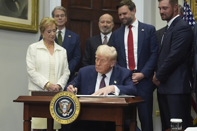 President Donald Trump signs an executive order restarting the Presidential Fitness Test in public schools as Secretary of Education Linda McMahon, from left, Treasury Secretary Scott Bessent, Commerce Secretary Howard Lutnick, Vice President JD Vance and professional golfer Bryson DeChambeau watch, Thursday, July 31, 2025, in the Roosevelt Room of the White House in Washington. (AP Photo/Jacquelyn Martin)