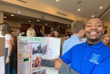 Jordan, a CEES student, shares his experiences on UC’s campus during a poster board presentation.