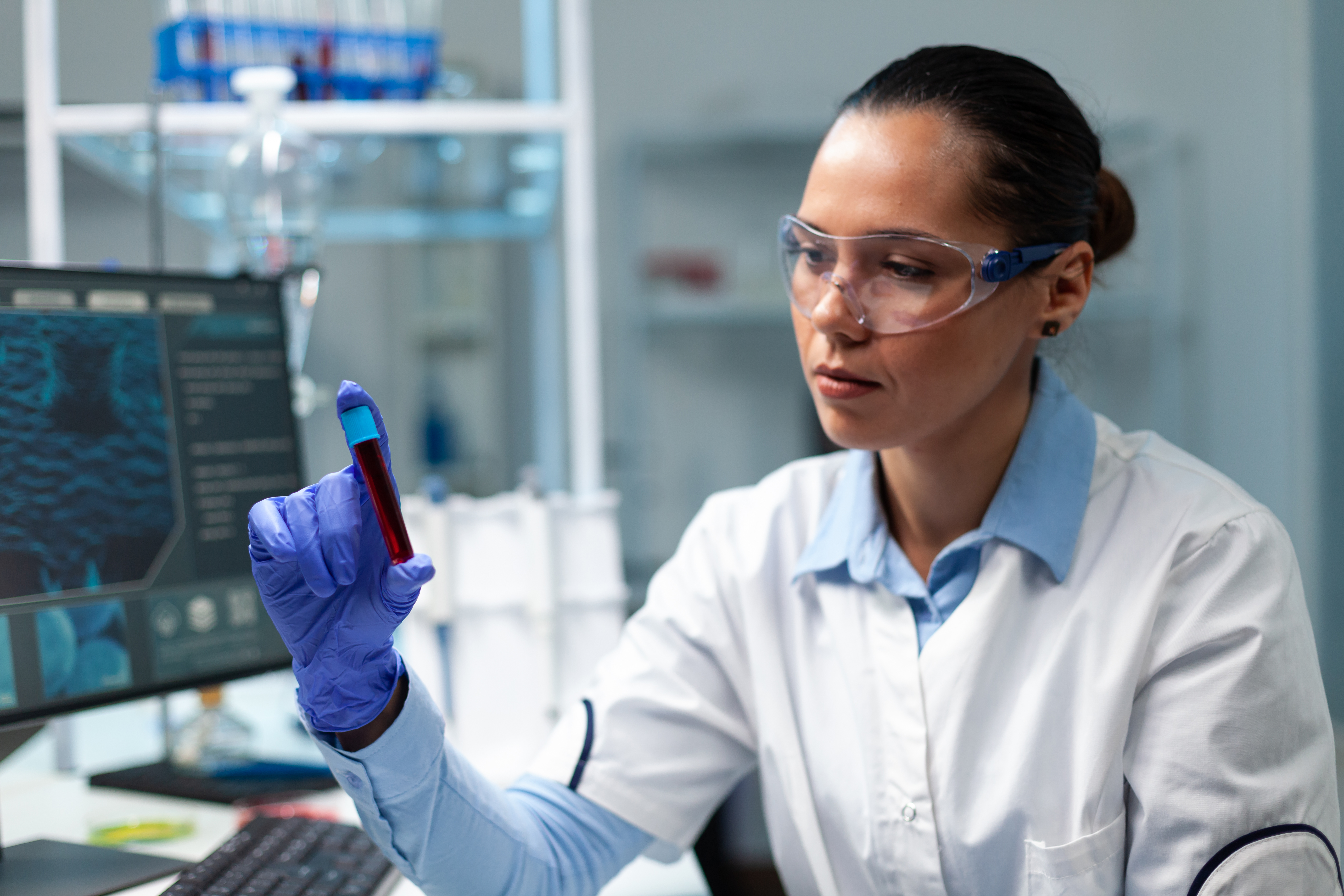 Researcher Biochemist Doctor Analyzing Transparent Vacutainer With Blood Working Microbiology Experiment Hospital Laboratory Biologist Woman Developing Medical Vaccine Using Biotechnology