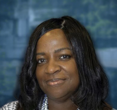 Professional headshot of a woman with long black hair smiling at the camera against a blurred blue background