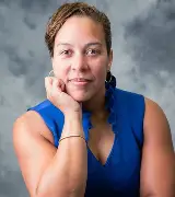Professional headshot of woman in blue sleeveless top against gray background