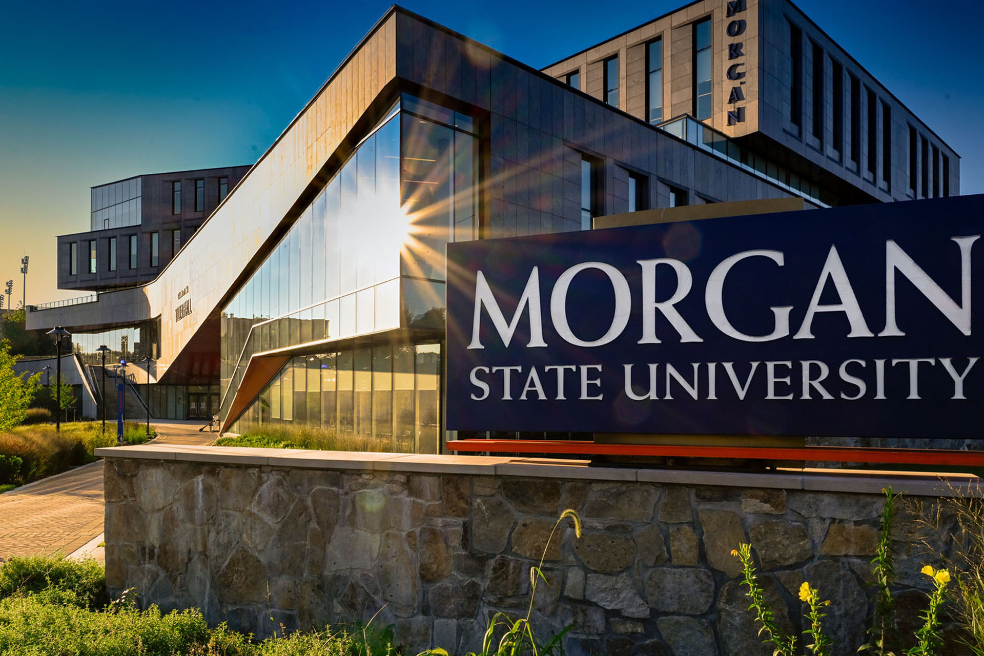 Morgan State University campus sign with modern building architecture against blue sky