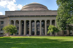 MIT's iconic domed building with classical columns and manicured lawn on a sunny day
